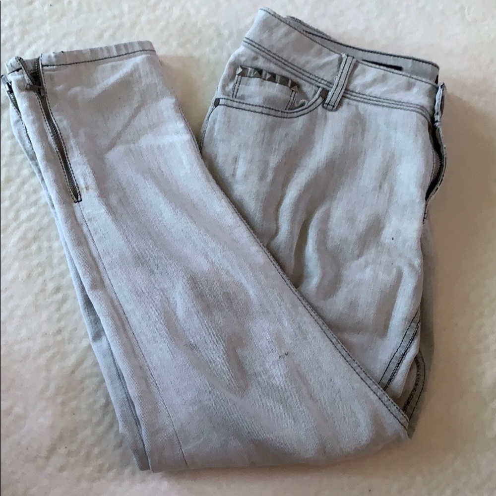 Grunge distressed and painted gray jeans